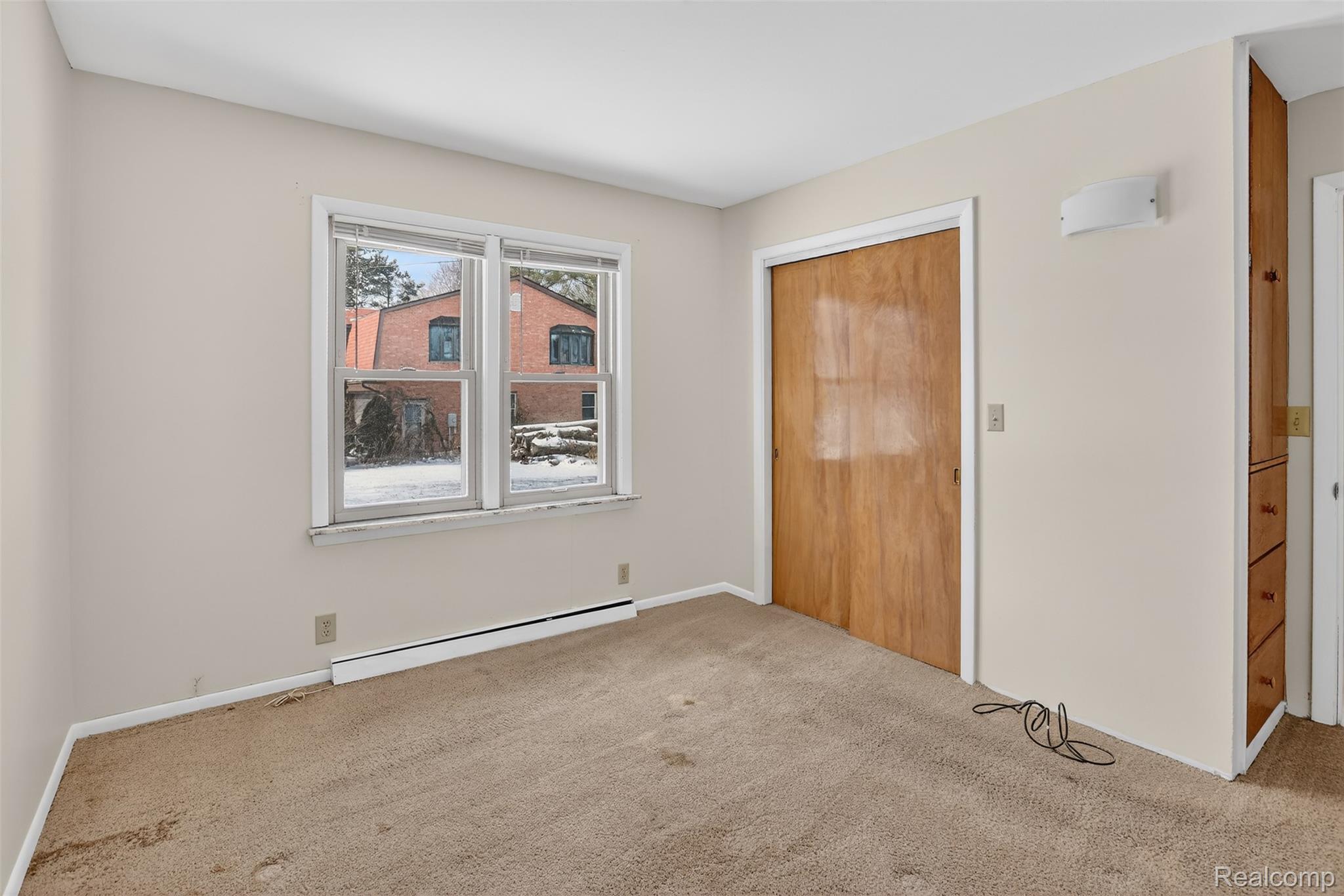 3241 Curtis Road Birch Run, MI 48415 - Photo 27 of 47 Unfurnished bedroom featuring baseboard heating, a closet, and carpet