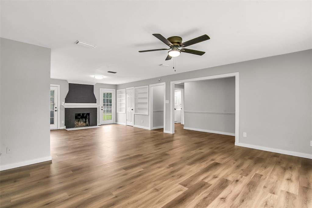 820 Lipscomb Street Bonham, TX 75418 - Photo 11 of 31 a view of an empty room with a fireplace and a window