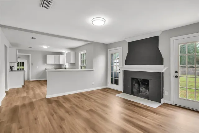 a view of a livingroom with a fireplace and window