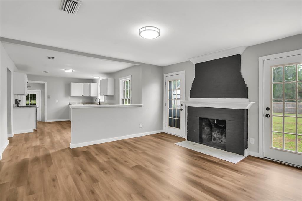 820 Lipscomb Street Bonham, TX 75418 - Photo 13 of 31 a view of a livingroom with a fireplace and window