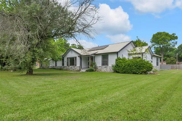 a front view of a house with a garden