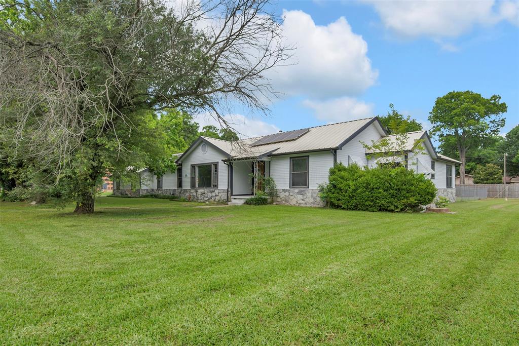 820 Lipscomb Street Bonham, TX 75418 - Photo 2 of 31 a front view of a house with a garden