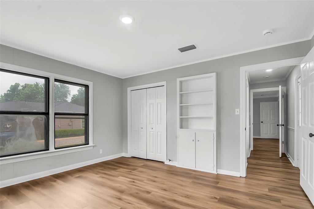 820 Lipscomb Street Bonham, TX 75418 - Photo 27 of 31 wooden floor in an empty room with a window