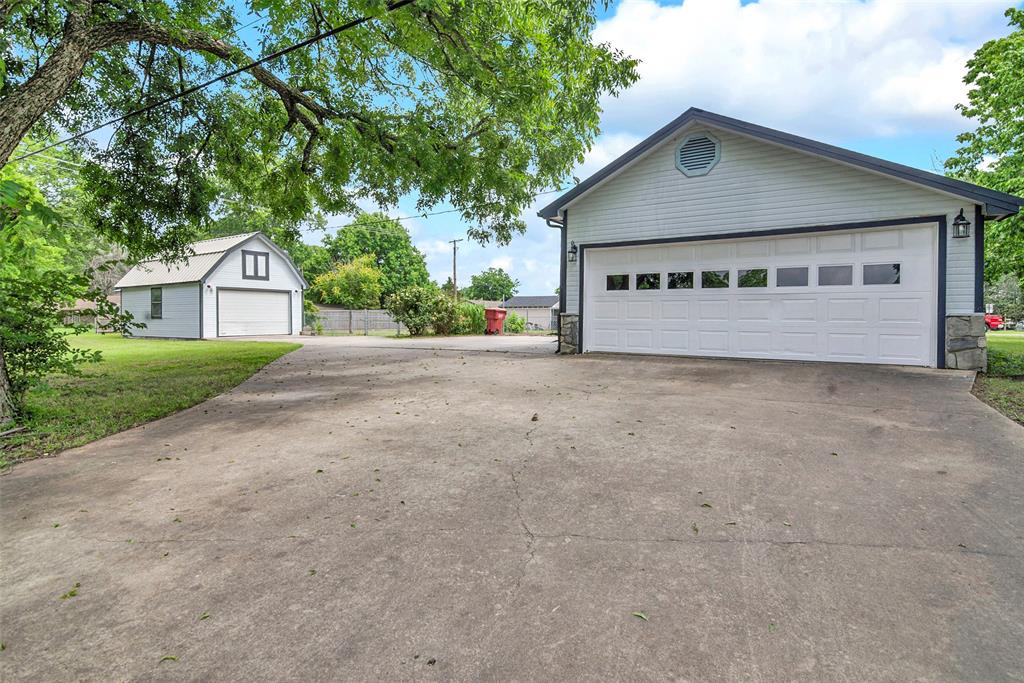 820 Lipscomb Street Bonham, TX 75418 - Photo 29 of 31 a view of house with a yard and large tree