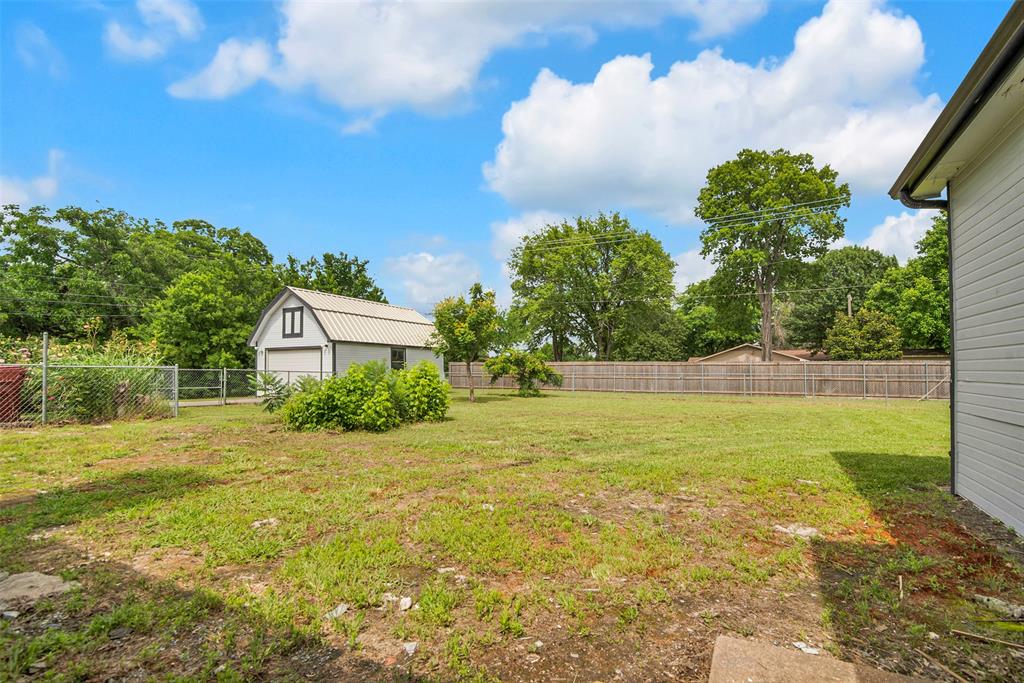 820 Lipscomb Street Bonham, TX 75418 - Photo 31 of 31 a front view of a house with a yard and garage
