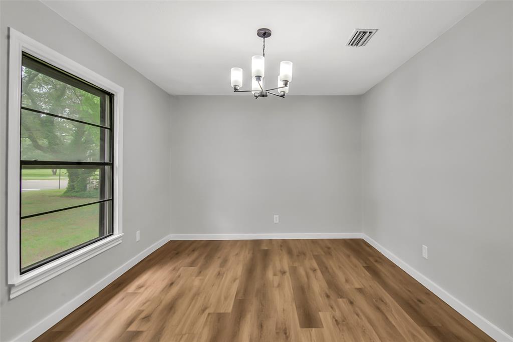 820 Lipscomb Street Bonham, TX 75418 - Photo 9 of 31 a view of empty room with wooden floor and fan
