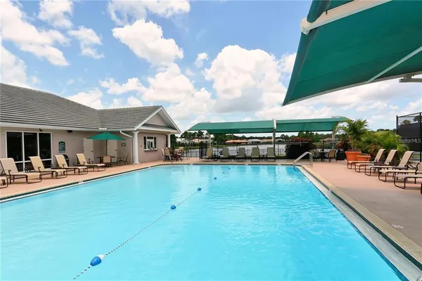 a view of a swimming pool with couches chairs and a table