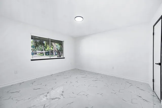 a bathroom with a double vanity sink mirror and bathtub