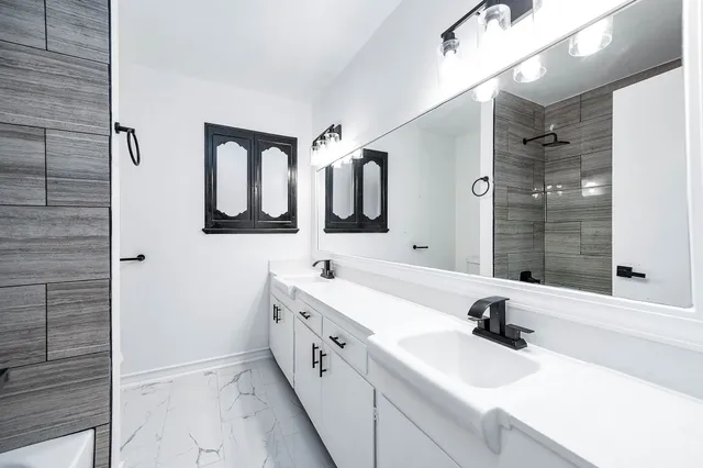 a bathroom with a shower and a window