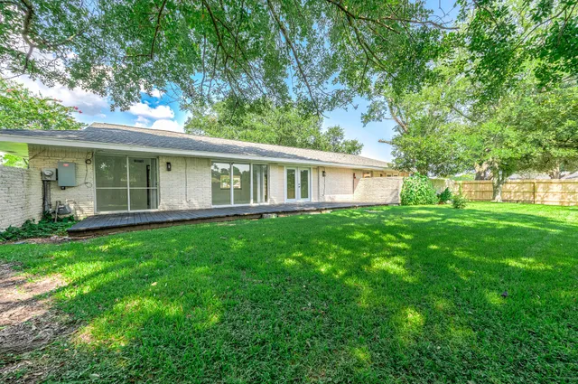 a view of a house that has a backyard