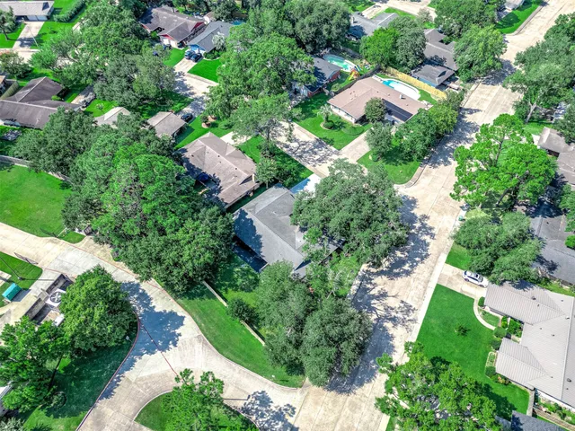 an aerial view of a house with yard