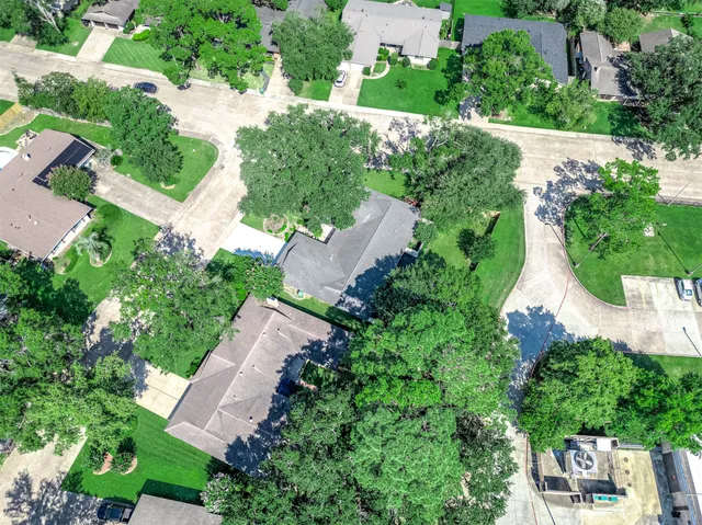 an aerial view of a house with a yard and outdoor seating