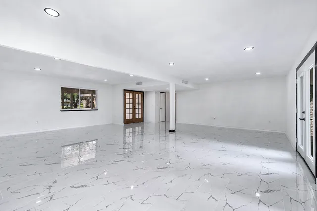 a kitchen with appliances a sink and cabinets