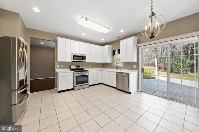 a kitchen with stainless steel appliances a refrigerator sink and microwave