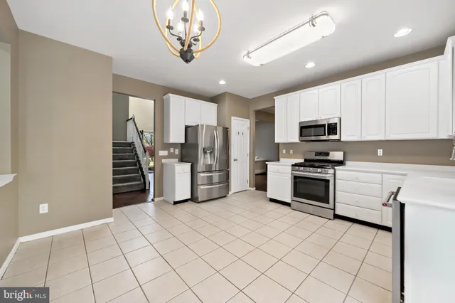 a kitchen with stainless steel appliances a refrigerator sink and microwave