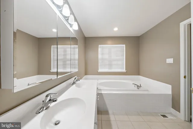 a bathroom with a bathtub and a sink