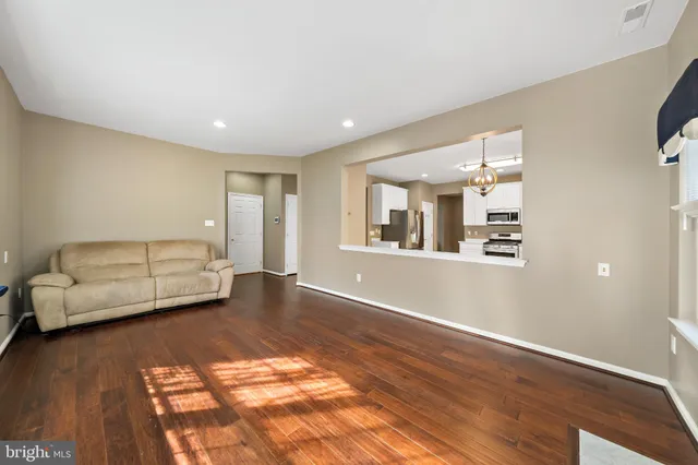 a living room with furniture and a hard wood floor