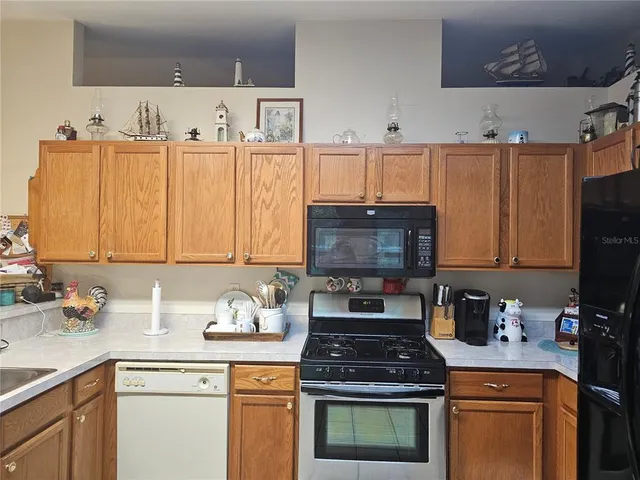 a kitchen with a sink appliances and cabinets