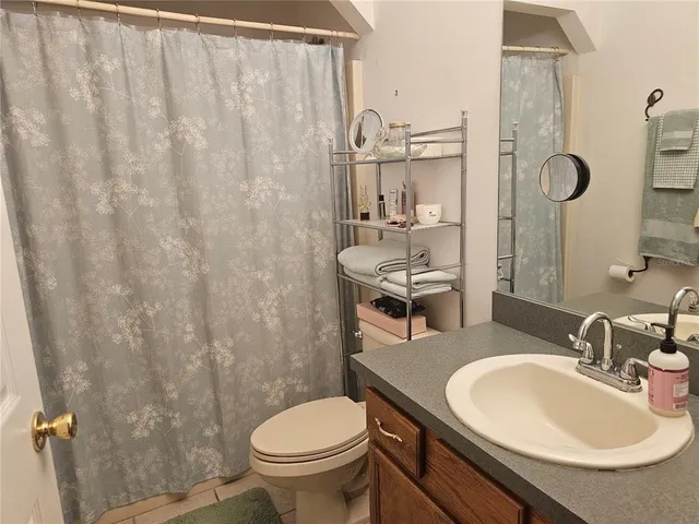 a bathroom with a sink toilet and mirror