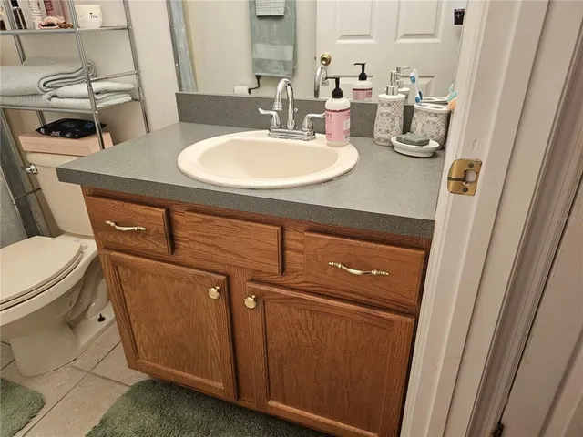 a bedroom with a bed and a computer on the desk