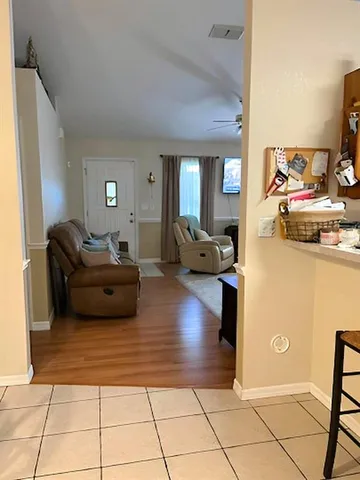 a kitchen with a sink a stove and chairs