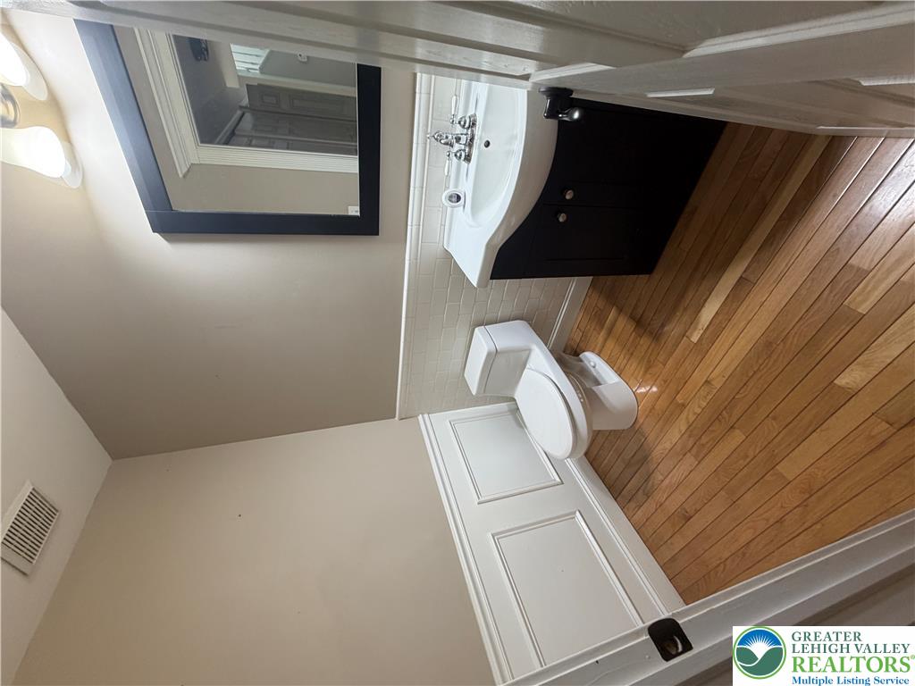 4157 Walter Road Bethlehem, PA 18020 - Photo 36 of 36 Hardwood floors and a sleek vanity define this well-appointed bathroom. Half Bathroom First Floor.