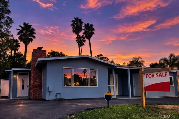 a man is sitting on the side of a building