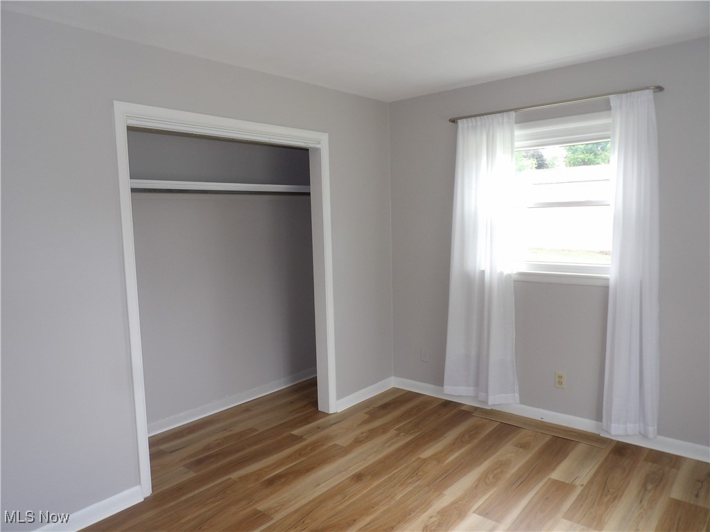 738 East Warner Road Akron, OH 44319 - Photo 11 of 23 Unfurnished bedroom featuring light LVT wood finished floors and a closet