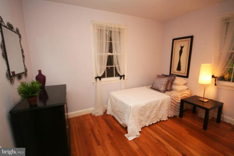 9220 Whitney Street Silver Spring, MD 20901 - Photo 9 of 30 a bedroom with a bed and a potted plant