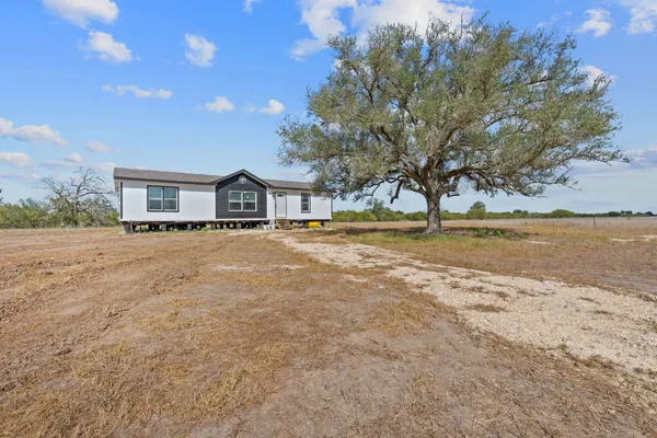 a house with trees in the background