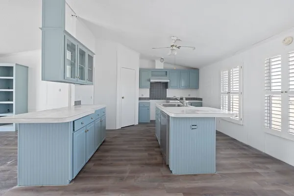 a kitchen with granite countertop a sink cabinets stainless steel appliances and a window