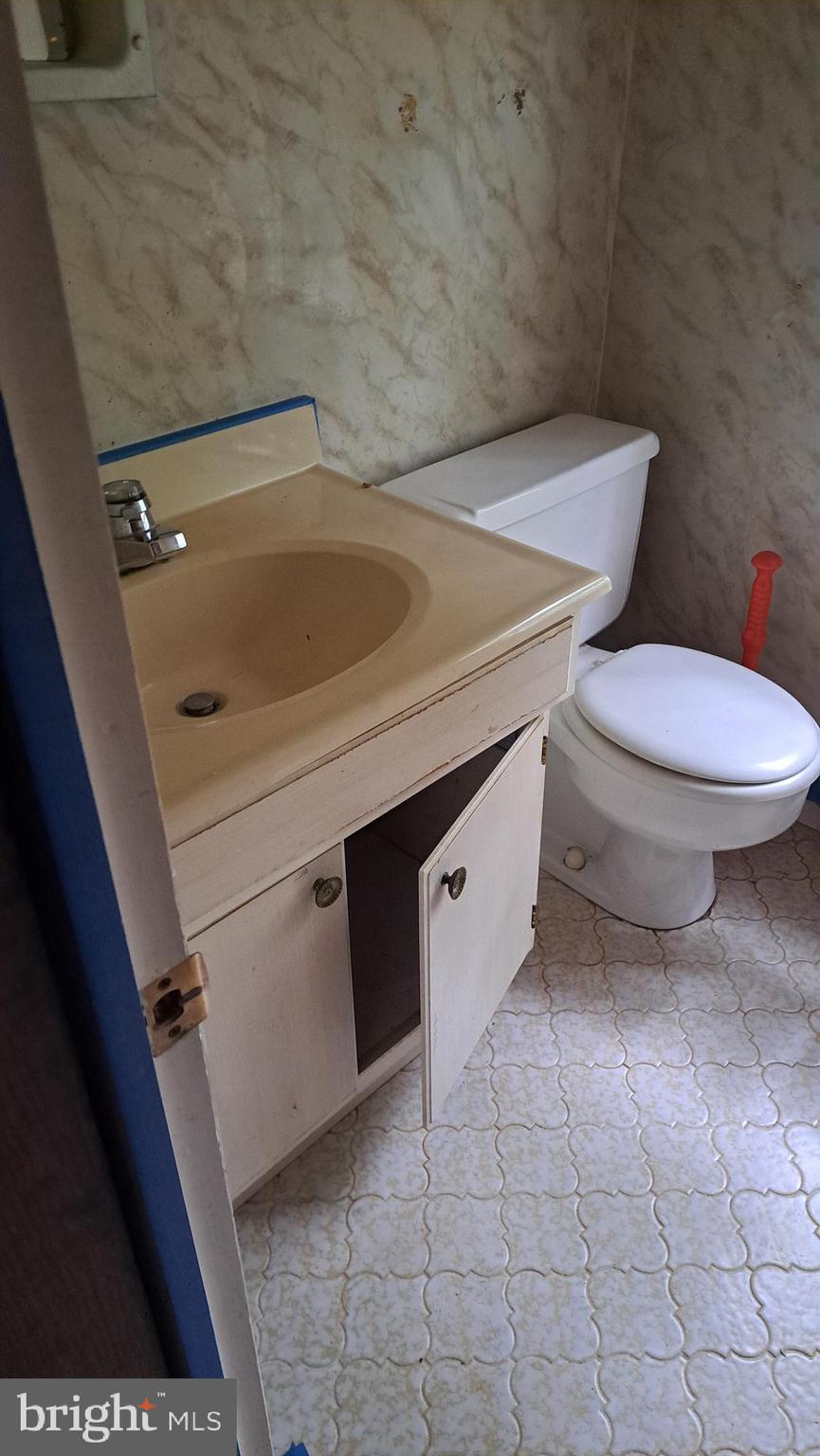 4401 East Joppa Road Perry Hall, MD 21236 - Photo 16 of 32 a bathroom with a granite countertop toilet and sink