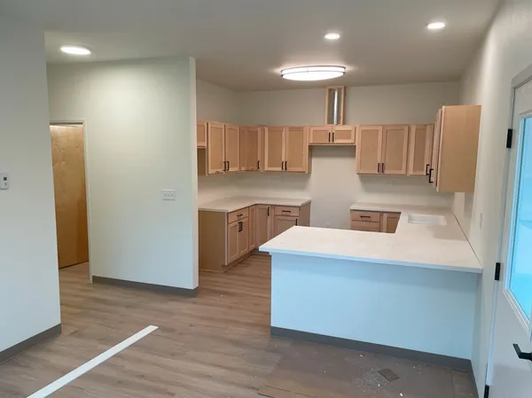 a kitchen with kitchen island a stove a refrigerator and a sink