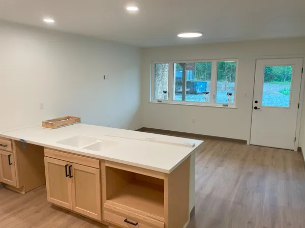 a room with a wooden floor and window