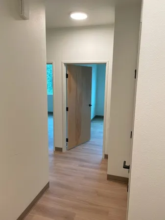 a view of hallway with wooden floor
