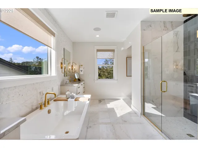 a bathroom with a sink mirror and a shower