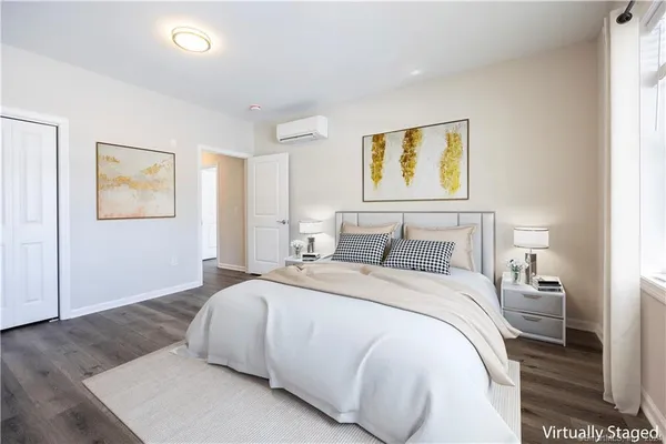 a bedroom with a bed and painting on the wall