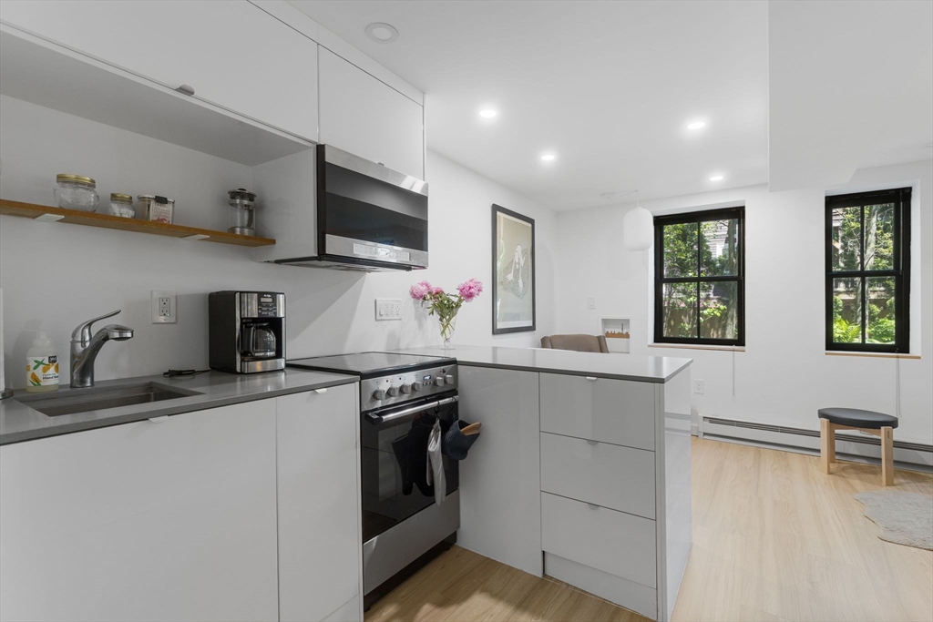 a kitchen with stainless steel appliances granite countertop a sink and a stove top oven