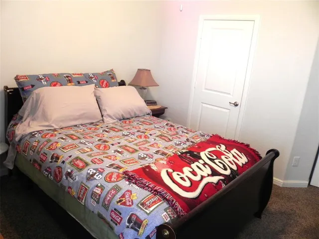 a bedroom with a bed and a night stand