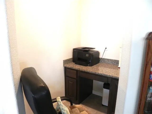 a living room with a chair and a potted plant