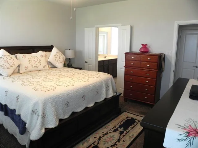 a bedroom with a bed and a dresser