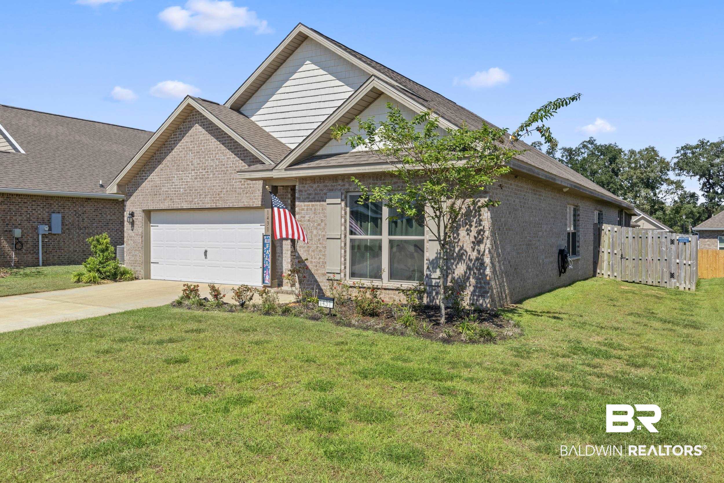 1431 Kairos Loop Foley, AL 36535 - Photo 2 of 27 View of front of house with a front yard and a garage