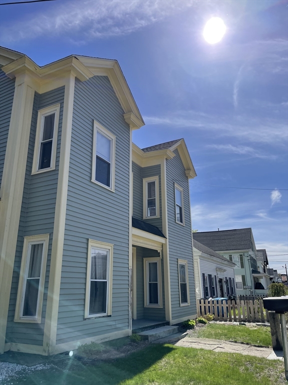 71 Main Street, Unit 2 Blackstone, MA 01504 - Photo 2 of 7 a front view of a house with garden
