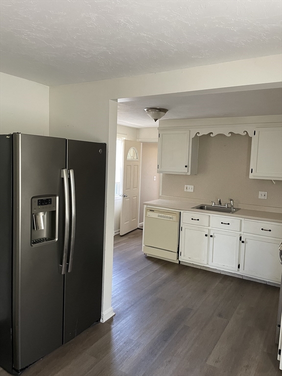 71 Main Street, Unit 2 Blackstone, MA 01504 - Photo 3 of 7 a kitchen with granite countertop white cabinets and stainless steel appliances