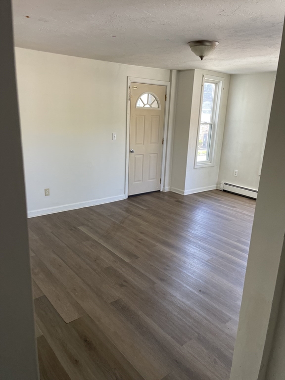 71 Main Street, Unit 2 Blackstone, MA 01504 - Photo 6 of 7 a view of an empty room with wooden floor and a window