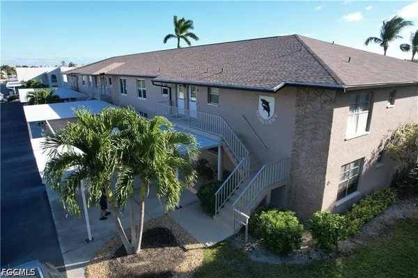 a aerial view of a house with a yard and potted plants
