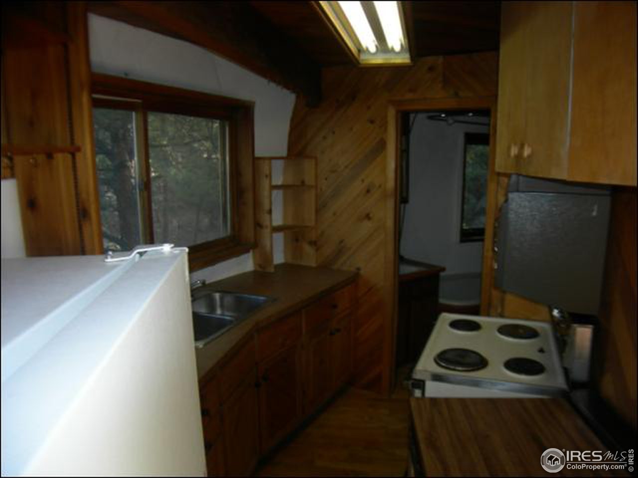 1488 Gold Run Road Boulder, CO 80302 - Photo 11 of 17 a kitchen with a sink a refrigerator and cabinets
