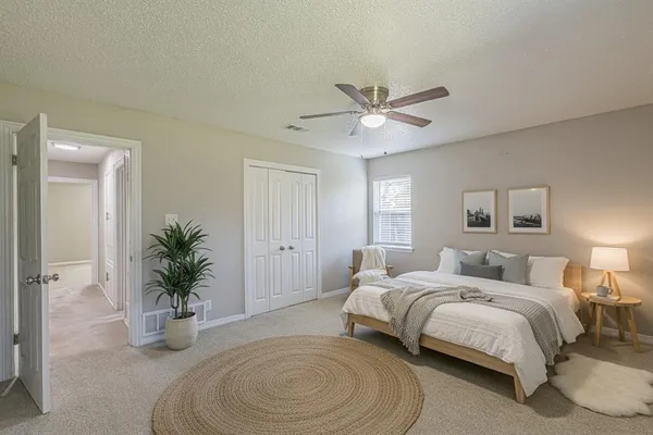 a view of a livingroom with a ceiling fan and window