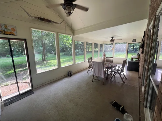 a dining room with furniture water view and a floor to ceiling window