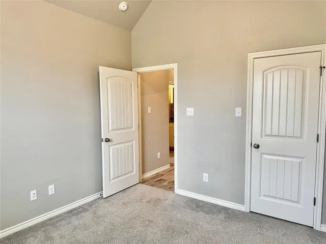 a view of an empty room with closet area